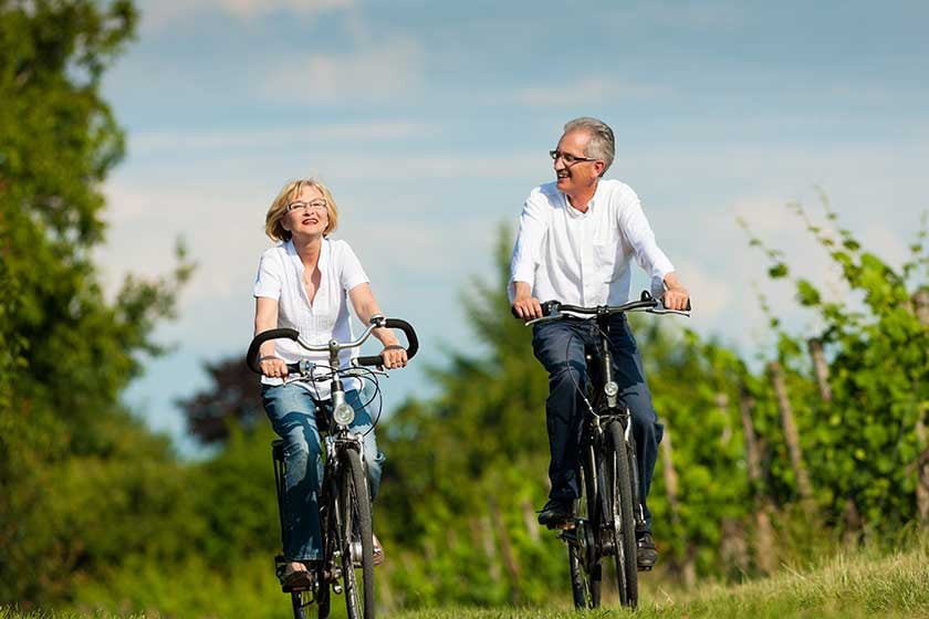 happy-couple-cycling-outdoors-in-summer